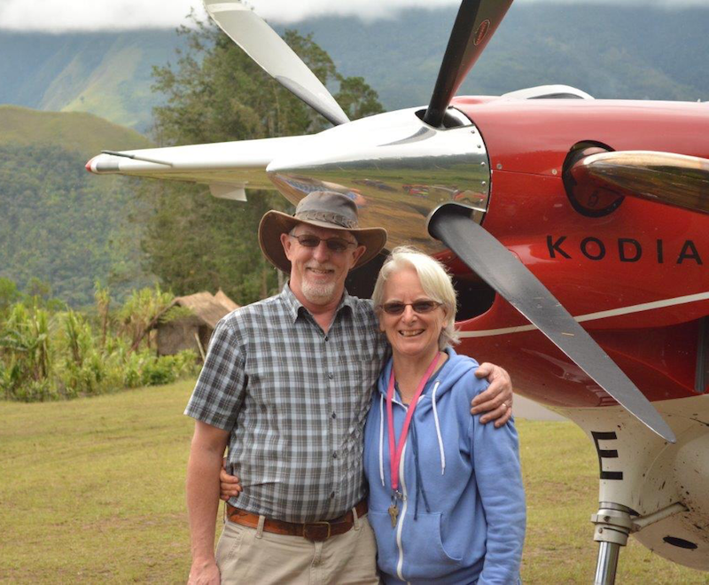 Andrew and Cathy standing in front of a Kodiak plane