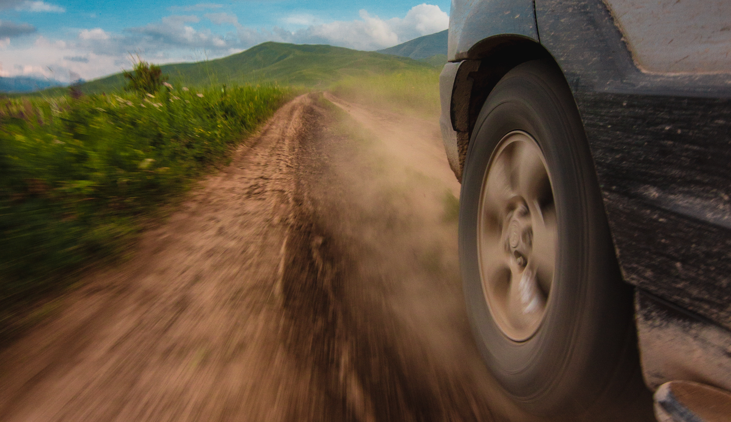 SUV wheel with a dirt road