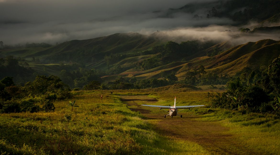 small plane on a mountainous runway