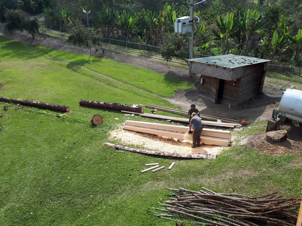 men milling wood with an Alaska saw-mill (with a chainsaw)