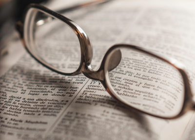 reading glasses on open Bible
