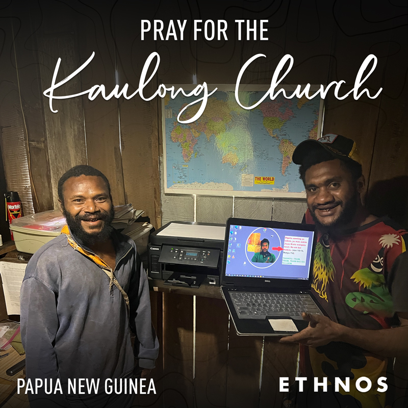 two men from Papua New Guinea with computer and printer